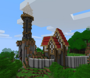 The medieval tower and the first building with a red roof. The picture also shows the unfinished stone wall perimeter.